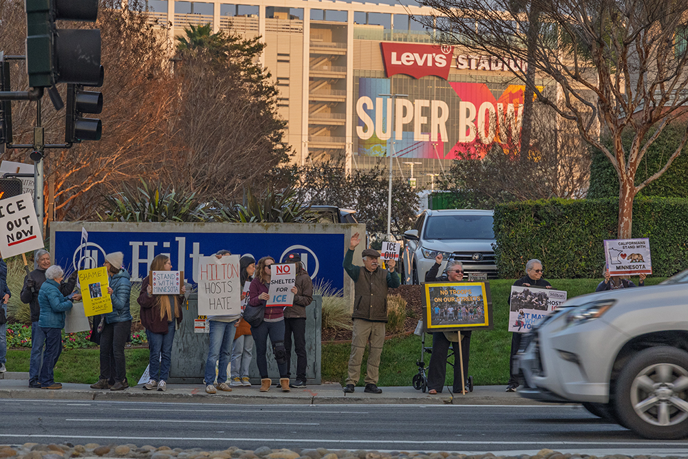 Protesters gathered outside Hilton Santa Clara holding signs against ICE
